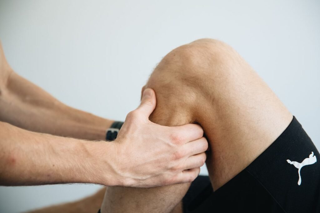 pexels-photo-20860607-20860607-2 Detailed image of a physiotherapy session focusing on knee massage treatment.